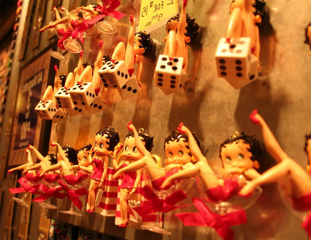 Period gift-shop display of Betty Boop figures and keychains posed in dice and novelty sunglasses.