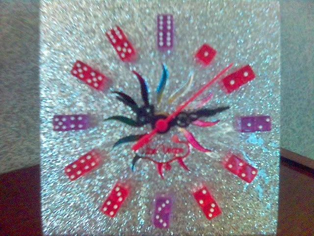 Glittery Las Vegas novelty clock with dice marking the hours.