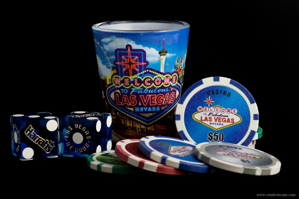 Las Vegas souvenir set with shot glass, dice, poker chips and a fifty-dollar chip coaster.