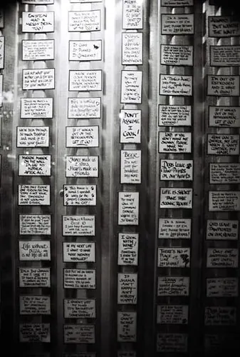 Rack of period novelty plaques printed with sarcastic household messages.