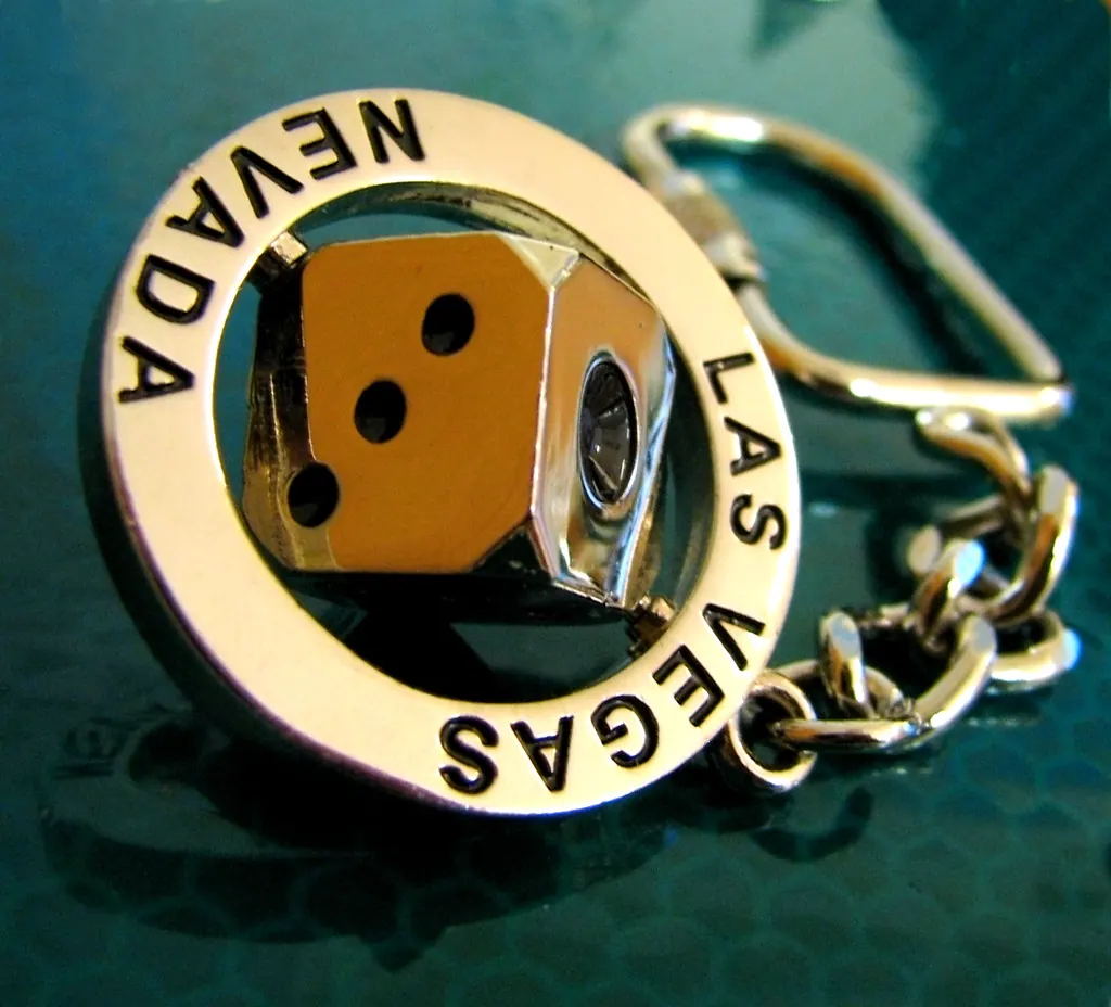 Silver Nevada souvenir keychain with a dangling pair of dice.
