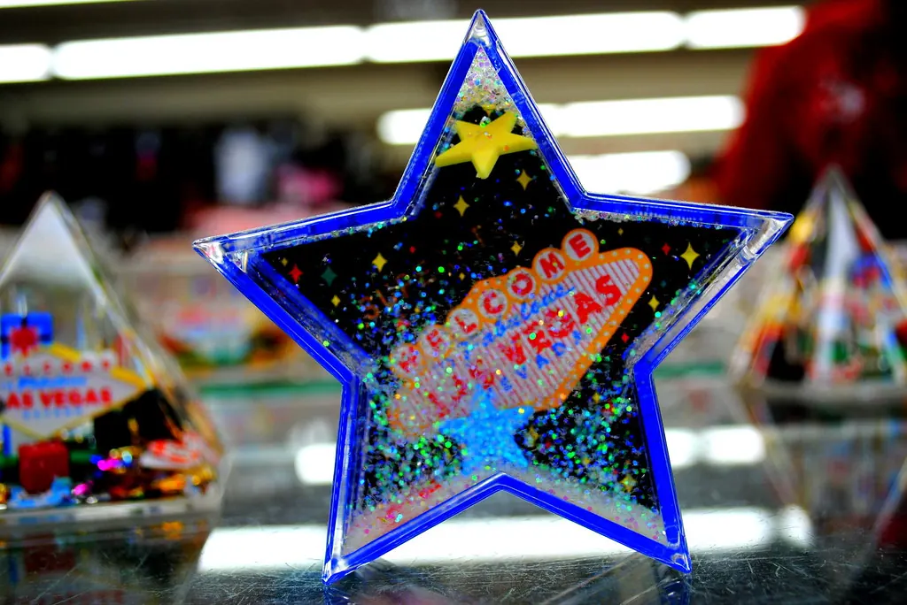 Blue star-shaped Las Vegas souvenir snow globe displayed in a gift shop.